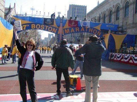 Diane crossing the Boston Marathon Finish Line Celebrating Her First Book